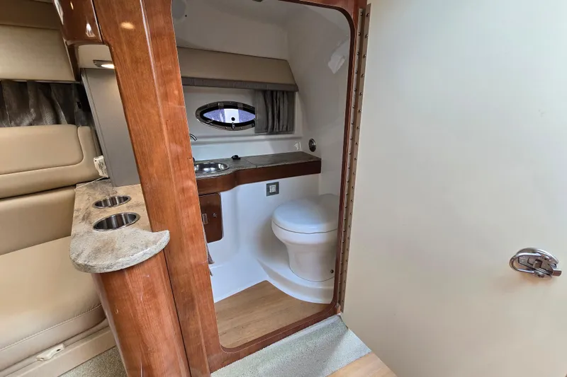 Slide: The Image of 2017 Formula 310 Sun Sport boat interior with compact bathroom and seating area. - 74