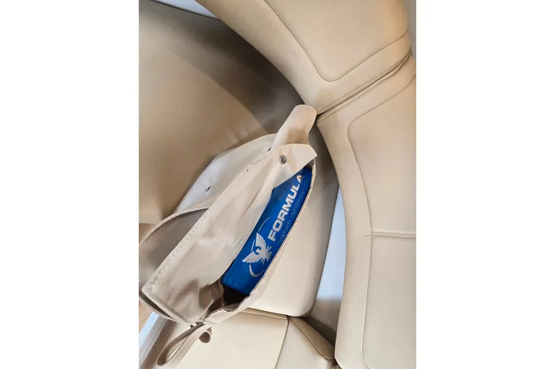 Slide: The Image of 2017 Formula 310 Sun Sport interior with beige seating and branded storage. - 78