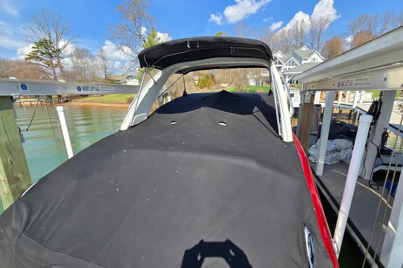 Slide: The Image of 2017 Formula 310 Sun Sport boat covered at a dock with scenic lake view. - 8