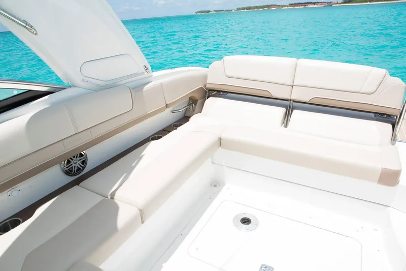 Slide: The Image of Manufacturer Provided Image: 2017 Formula 310 Sun Sport boat interior with beige seating on turquoise water. - 84