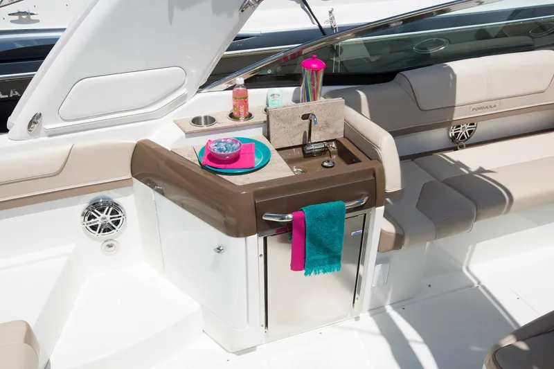 Slide: The Image of Manufacturer Provided Image: 2017 Formula 310 Sun Sport boat interior with kitchenette and seating area. - 85