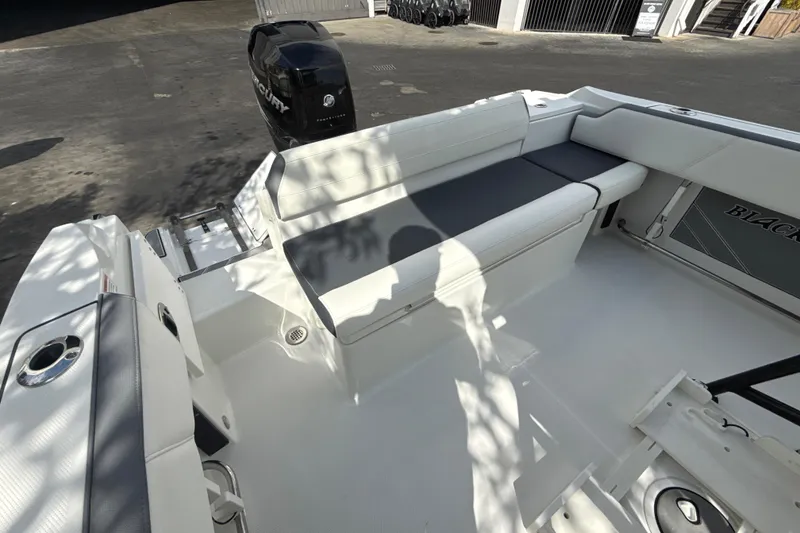 Slide: The Image of 2018 Blackfin 212 CC boat interior with seating and Mercury outboard motor. - 10