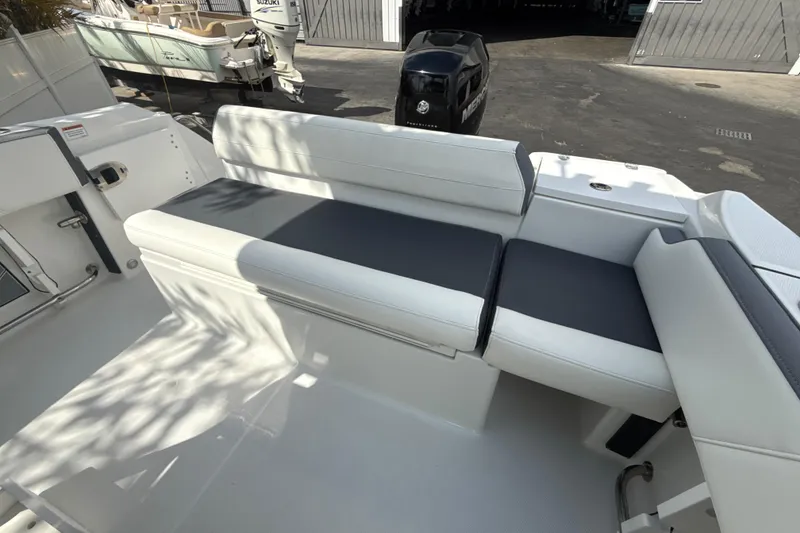Slide: The Image of 2018 Blackfin 212 CC boat with white and gray seating in a sunny outdoor setting. - 11