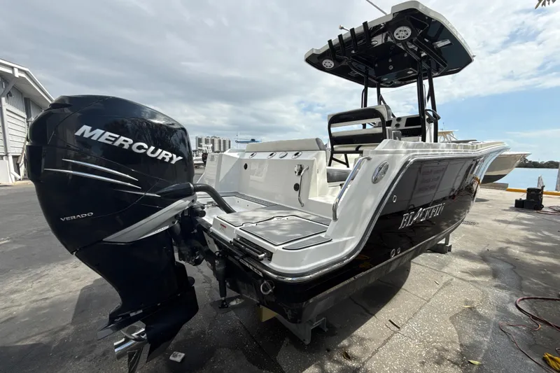 Slide: The Image of 2018 Blackfin 212 CC boat with Mercury Verado engine, docked near waterfront. - 15