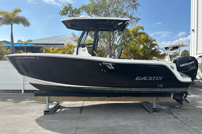 Slide: The Image of 2018 Blackfin 212 CC boat with Mercury engine on display outdoors. - 19