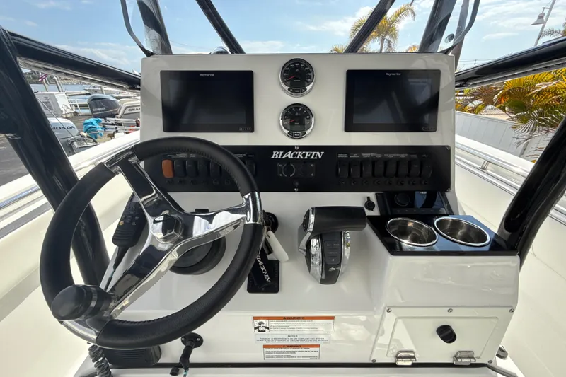 Slide: The Image of 2018 Blackfin 212 CC boat dashboard with steering wheel, controls, and dual displays. - 5
