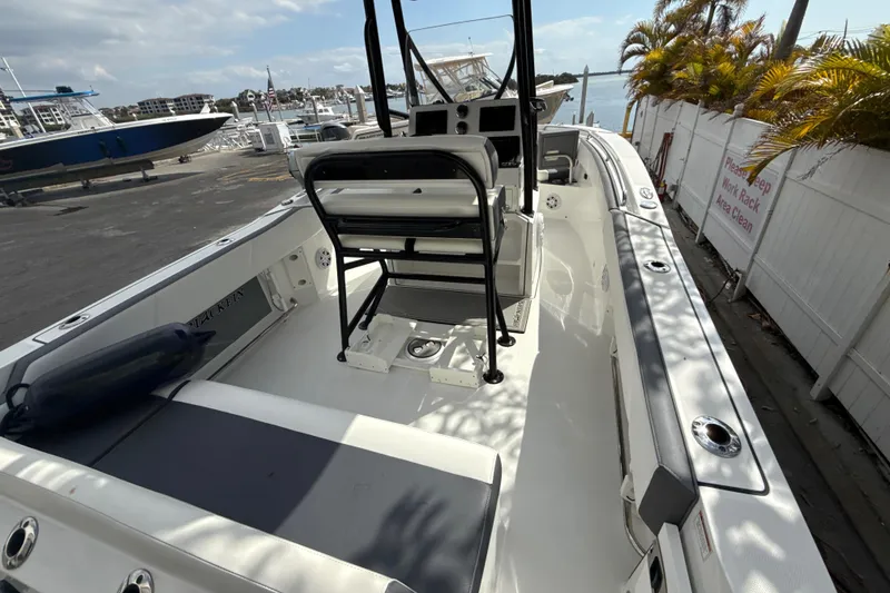 Slide: The Image of 2018 Blackfin 212 CC boat docked, showcasing spacious deck and seating area. - 8
