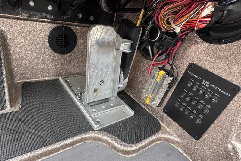 Slide: The Image of Interior view of a 2026 Triton 18 TrX boat showing pedal and wiring panel. - 20