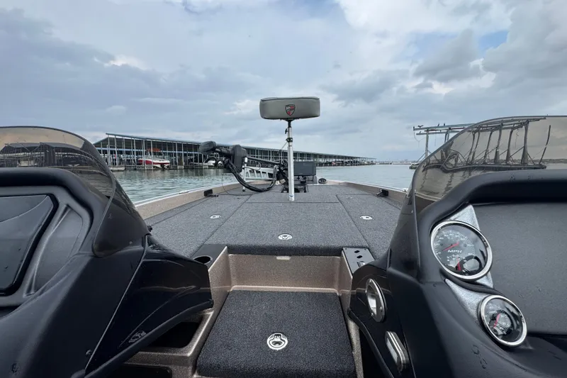 Slide: The Image of 2026 Triton 18 TrX boat interior with dashboard and lake view. - 23