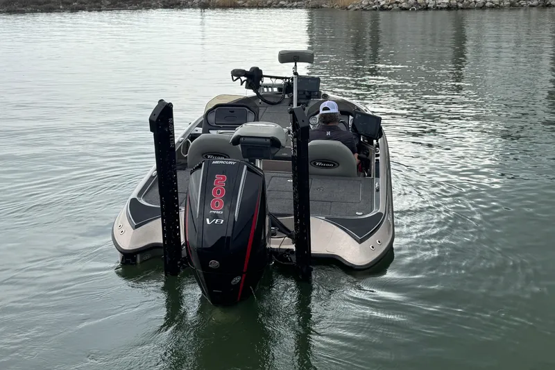 Slide: The Image of 2026 Triton 18 TrX boat with Mercury 200 V8 engine on calm water. - 5