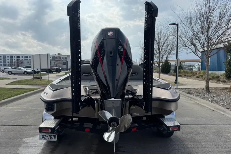 Slide: The Image of 2026 Triton 18 TrX boat rear view with motor and dual power poles. - 8