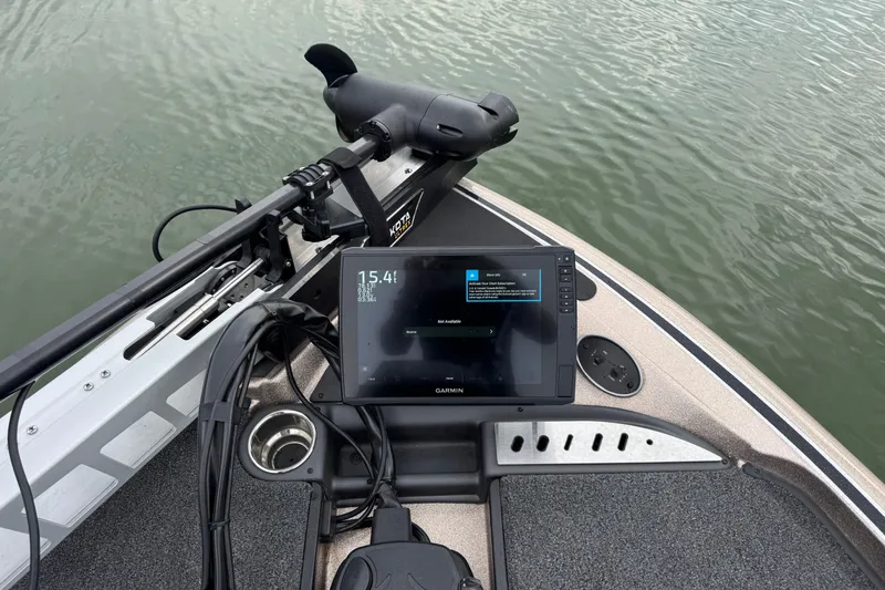 Slide: The Image of 2026 Triton 18 TrX boat with Garmin fishfinder on calm water. - 9