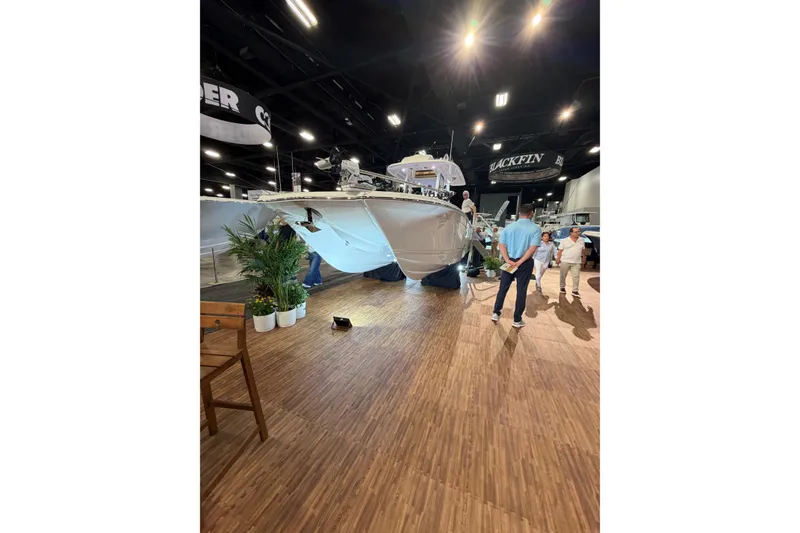 The Image of 2026 Caymas 29 CT boat displayed at an indoor exhibition with visitors observing. - 0