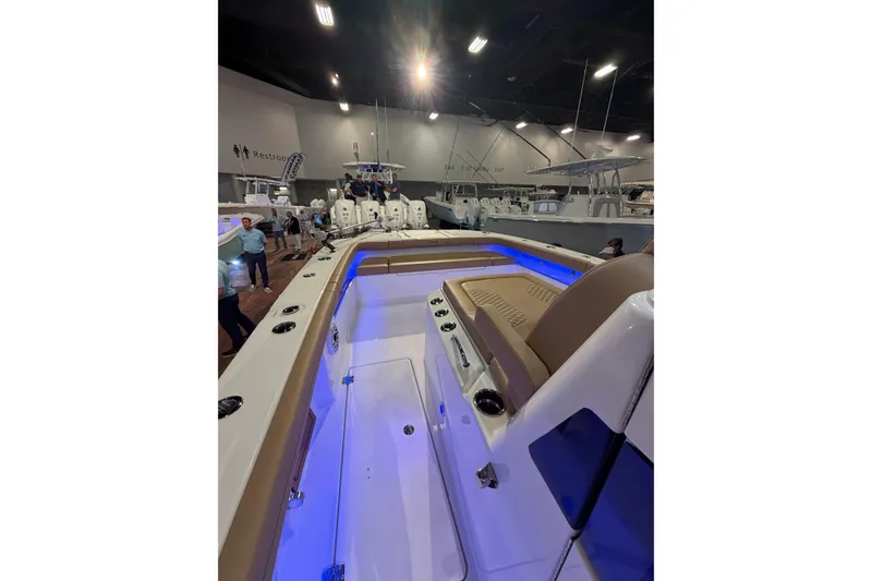 Slide: The Image of 2026 Caymas 29 CT boat interior with blue LED lighting at a boat show. - 2