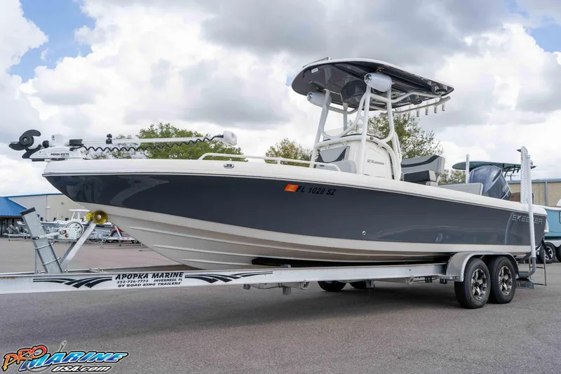 The Image of 2021 Skeeter SX2550 Family boat on trailer, displayed outdoors under cloudy sky. - 1
