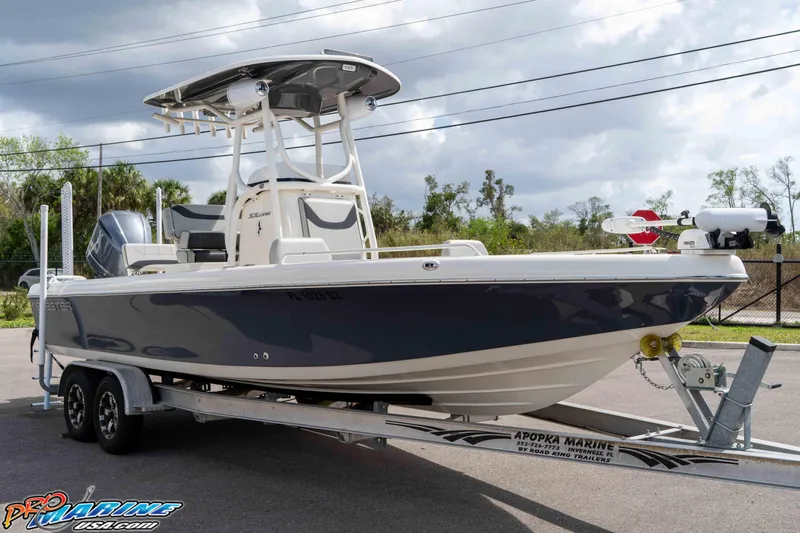 Slide: The Image of 2021 Skeeter SX2550 Family boat on trailer, parked outdoors under cloudy sky. - 10