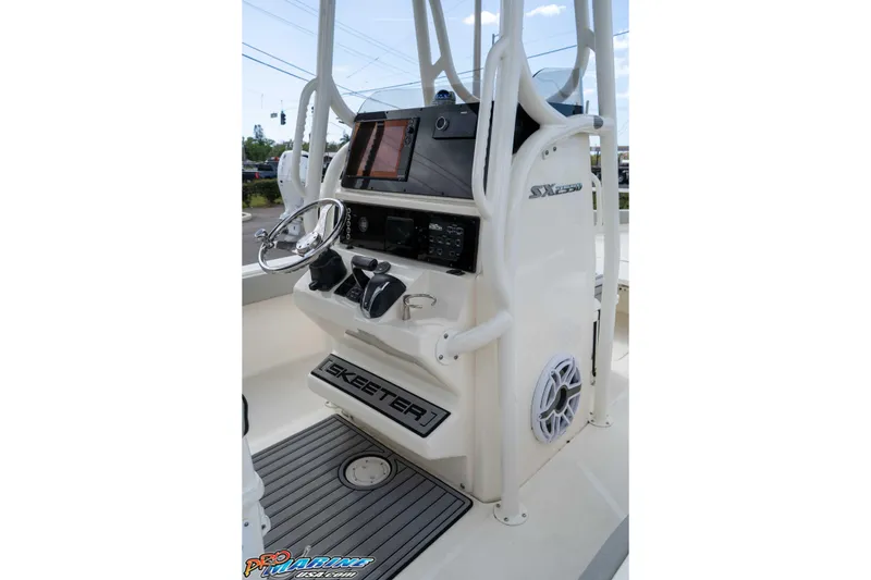 Slide: The Image of 2021 Skeeter SX2550 Family boat console with steering wheel and electronic controls. - 25