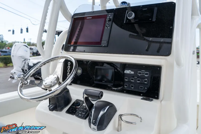 Slide: The Image of 2021 Skeeter SX2550 Family boat dashboard with steering wheel and electronic controls. - 26