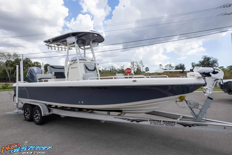 Slide: The Image of 2021 Skeeter SX2550 Family boat on trailer, parked outdoors under cloudy sky. - 30