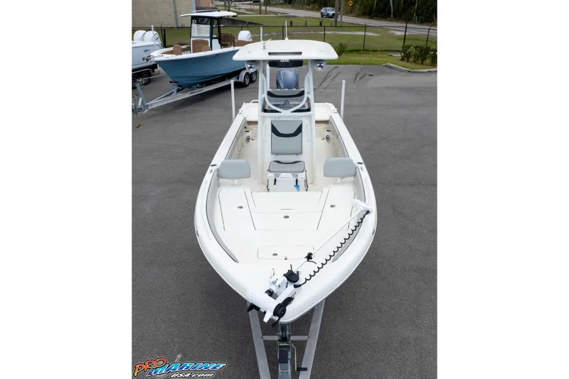 Slide: The Image of 2021 Skeeter SX2550 Family boat on trailer, showcasing spacious deck and seating. - 35