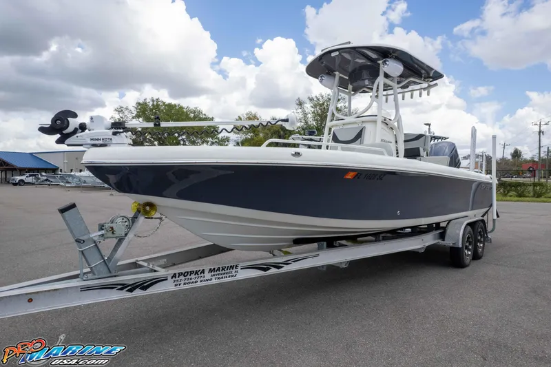 Slide: The Image of 2021 Skeeter SX2550 Family boat on trailer, parked outdoors under cloudy sky. - 36