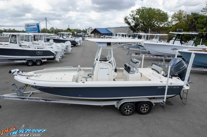 Slide: The Image of 2021 Skeeter SX2550 Family boat on trailer at dealership, surrounded by other boats. - 40