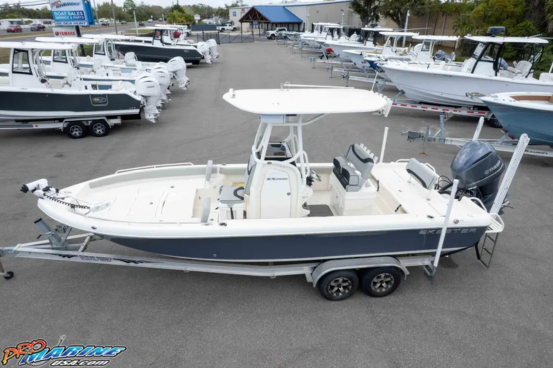 Slide: The Image of 2021 Skeeter SX2550 Family boat on trailer at dealership, surrounded by other boats. - 41