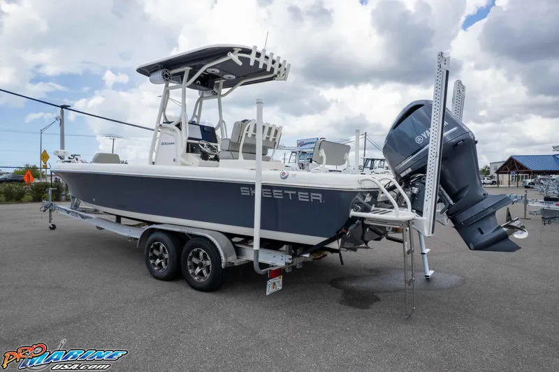 Slide: The Image of 2021 Skeeter SX2550 Family boat on trailer, featuring Yamaha outboard motor. - 42