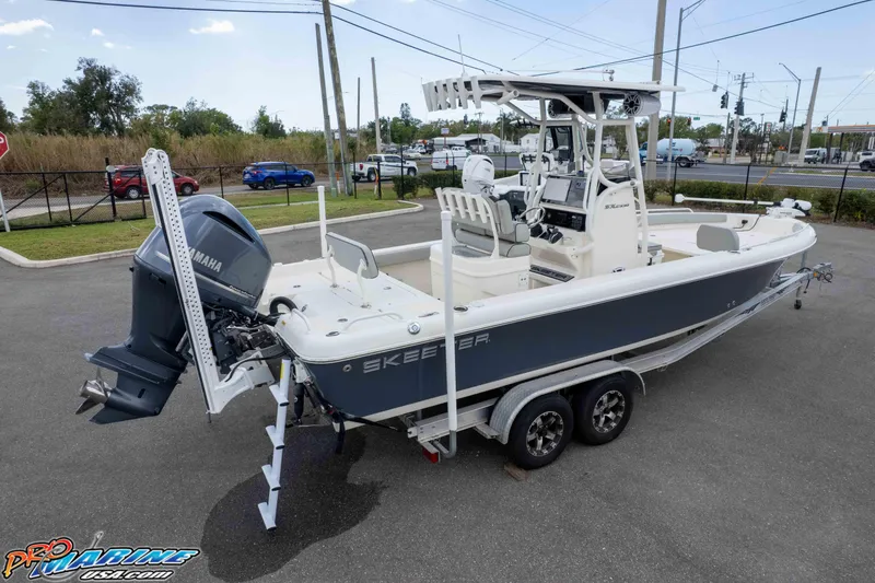 Slide: The Image of 2021 Skeeter SX2550 Family boat on trailer with Yamaha outboard motor in parking lot. - 49