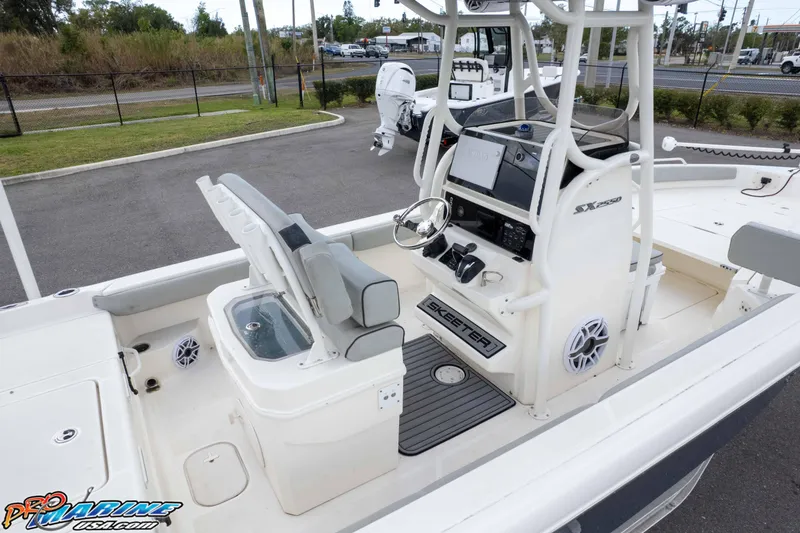 Slide: The Image of 2021 Skeeter SX2550 Family boat interior with steering console and seating area. - 55