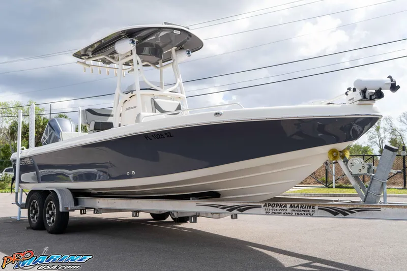 Slide: The Image of 2021 Skeeter SX2550 Family boat on trailer, parked outdoors under cloudy sky. - 9