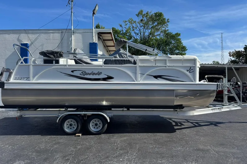 The Image of 2026 JC Spirit 222 TT Sport pontoon boat on trailer, parked outdoors. - 0