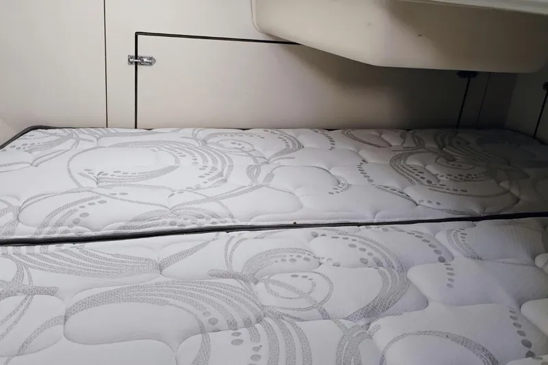 Slide: The Image of Interior cabin of 2006 Hunter 27 sailboat with patterned mattress. - 16