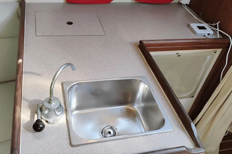 Slide: The Image of Compact kitchen sink in a 2006 Hunter 27 sailboat galley. - 17