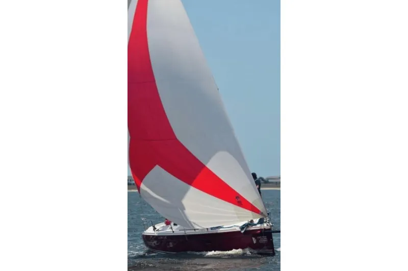Slide: The Image of Sailing yacht Hunter 27 (2006) with red and white sails on open water. - 19