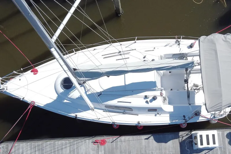 Slide: The Image of Aerial view of 2006 Hunter 27 sailboat docked, showcasing sleek design and deck layout. - 5