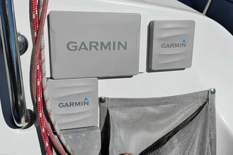 Slide: The Image of Garmin devices on a 2006 Hunter 27 sailboat, with red ropes and mesh pocket. - 8