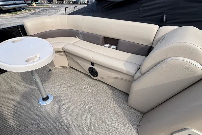 Slide: The Image of 2023 Bentley 243 Navigator boat interior with beige seating and round table. - 11