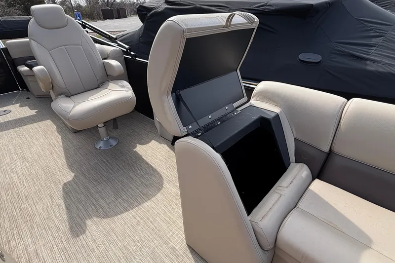 Slide: The Image of 2023 Bentley 243 Navigator boat interior with beige seating and storage compartment. - 12