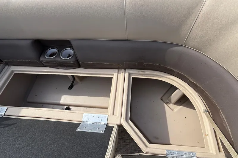 Slide: The Image of Open storage compartments in a 2023 Bentley 243 Navigator boat interior. - 13