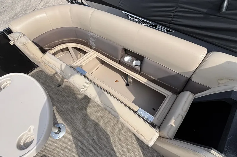 Slide: The Image of 2023 Bentley 243 Navigator boat interior with beige seating and cup holders. - 15