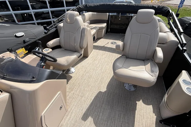 Slide: The Image of 2023 Bentley 243 Navigator boat interior with beige seating and steering console. - 17