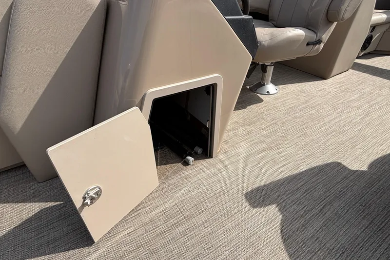 Slide: The Image of Open storage compartment on 2023 Bentley 243 Navigator boat interior with beige seating. - 18