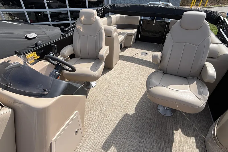 Slide: The Image of 2023 Bentley 243 Navigator boat interior with beige seating and steering console. - 19