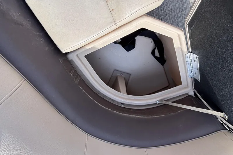 Slide: The Image of 2023 Bentley 243 Navigator boat storage compartment with beige upholstery and open hatch. - 21