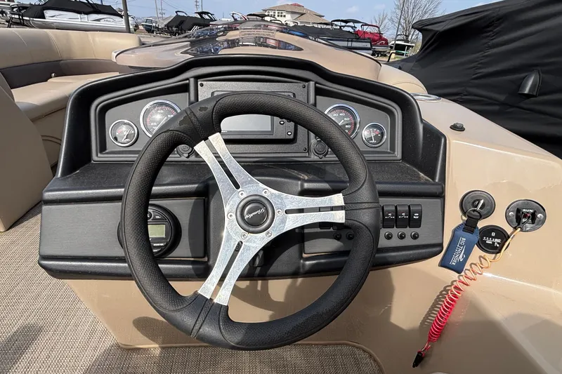 Slide: The Image of 2023 Bentley 243 Navigator boat dashboard with steering wheel and control panel. - 24