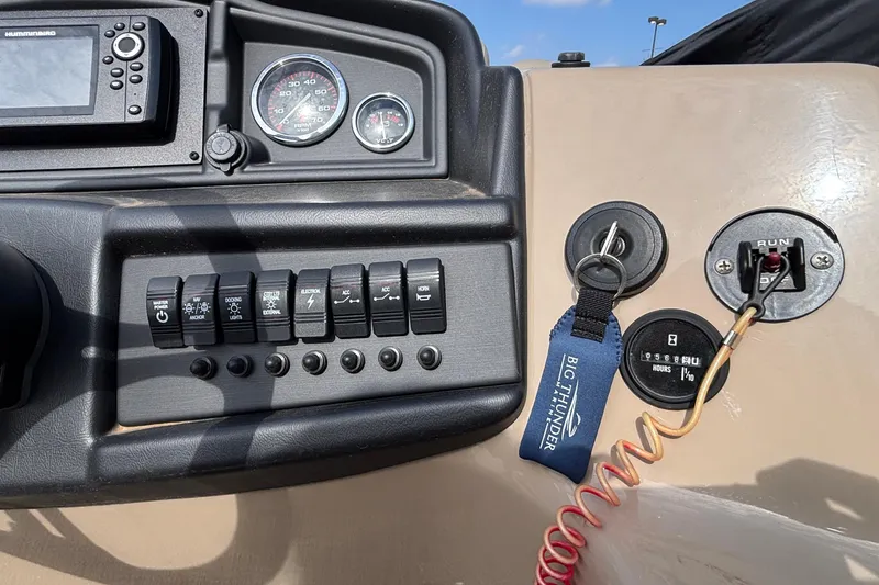 Slide: The Image of Control panel of a 2023 Bentley 243 Navigator boat with switches and key ignition. - 26