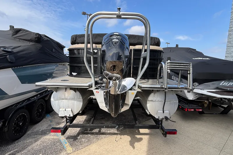 Slide: The Image of 2023 Bentley 243 Navigator pontoon boat with outboard motor, docked and covered. - 5