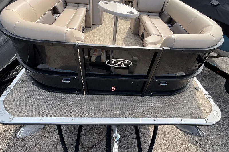 Slide: The Image of 2023 Bentley 243 Navigator pontoon boat with beige seating and sleek black exterior. - 7