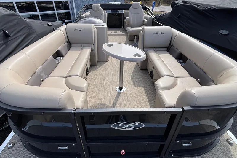 Slide: The Image of 2023 Bentley 243 Navigator pontoon boat with beige seating and central table. - 8